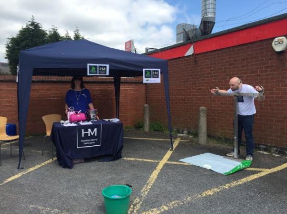 Harrison Murray staff operate a "stocks" fun stall